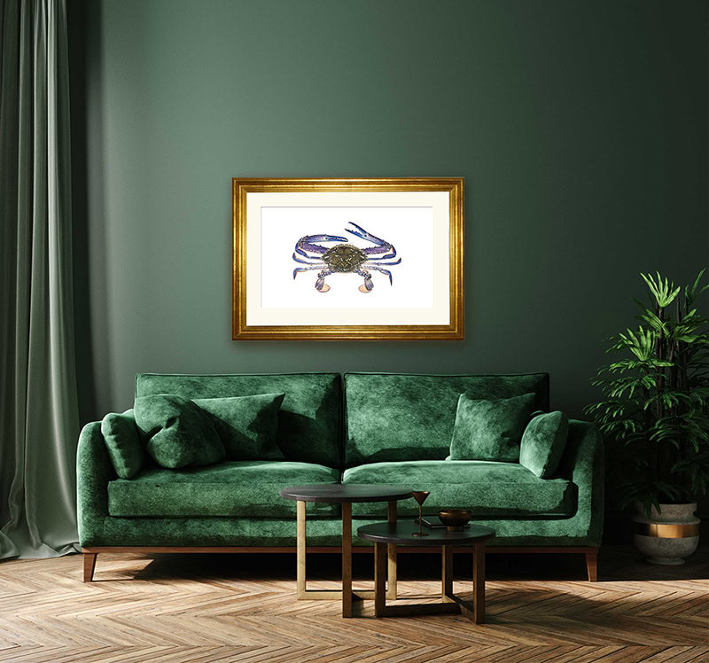 Fine art print framed on a dark green wall and green sofa.