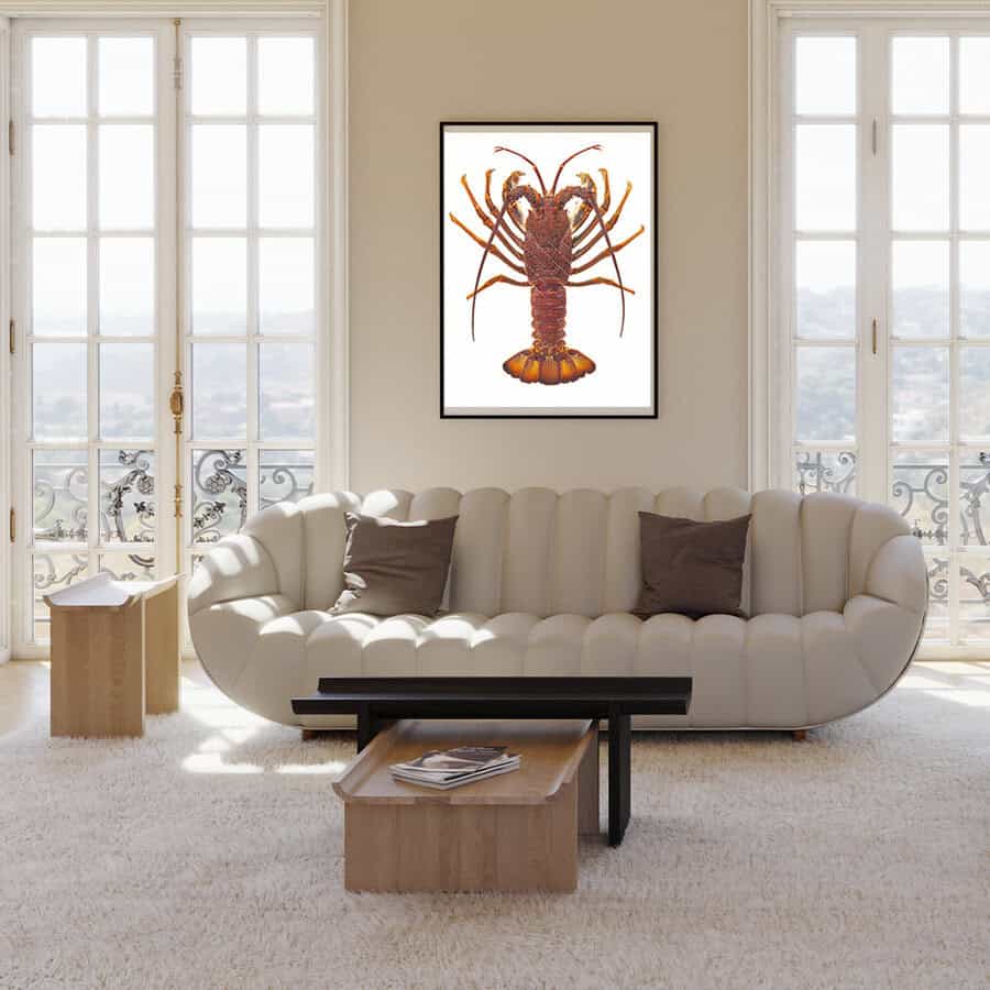 Modern living room with a beige sofa, coffee table, and framed artwork of a Southern Rock Lobster.