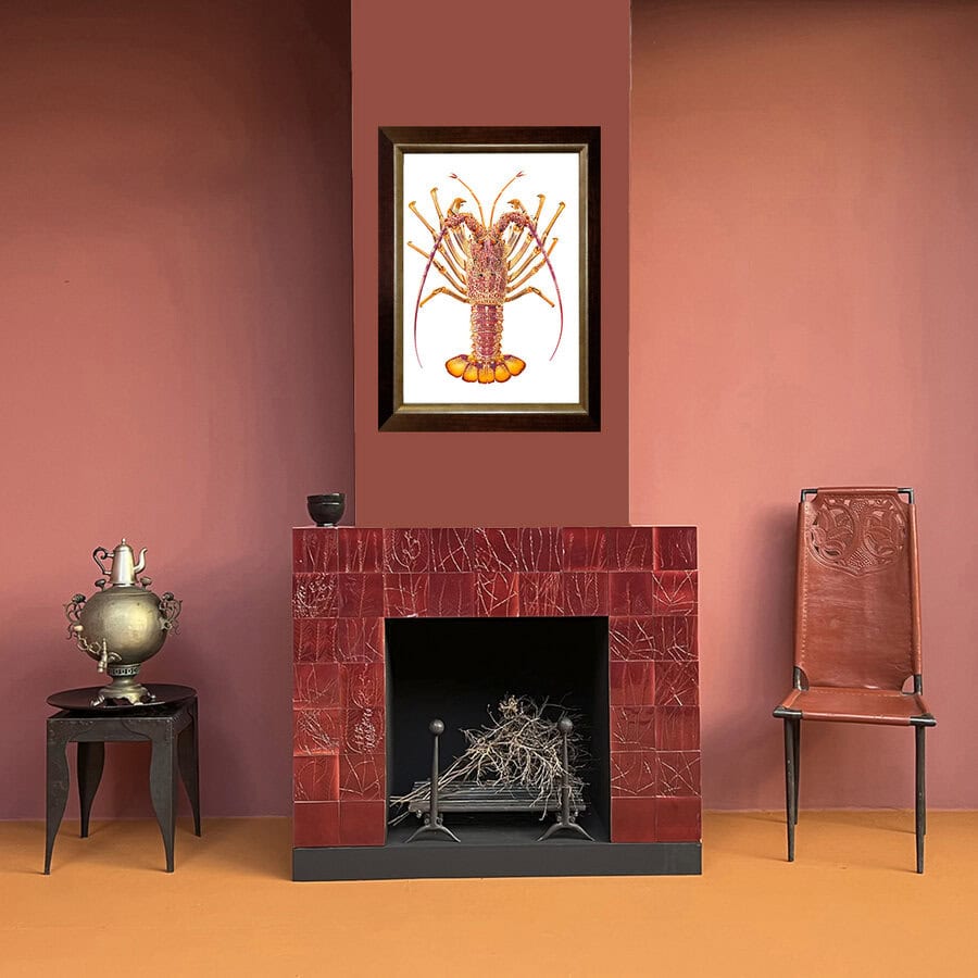 Room interior with a red fireplace, decorative chair, and southern rock lobster framed artwork on a pink wall.